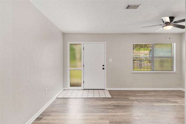 915 NW 40th Ave, Gainesville, Fl, FL 32605 - entryway featuring wood finished floors, healthy amount of natural light, a ceiling fan, and baseboards