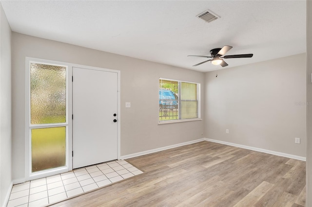 915 NW 40th Ave, Gainesville, Fl, FL 32605 - foyer entrance with light wood-style flooring, ceiling fan, and baseboards