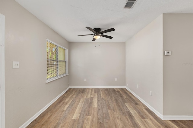 915 NW 40th Ave, Gainesville, Fl, FL 32605 - spare room with ceiling fan, wood finished floors, and baseboards