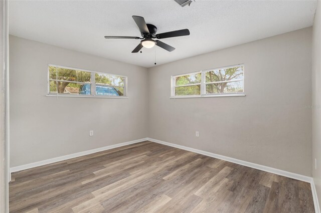 915 NW 40th Ave, Gainesville, Fl, FL 32605 - unfurnished room with wood finished floors, baseboards, and ceiling fan