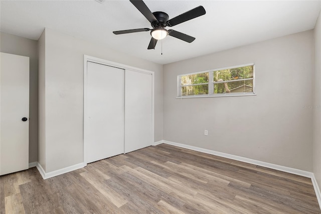 915 NW 40th Ave, Gainesville, Fl, FL 32605 - unfurnished bedroom with wood finished floors, a closet, baseboards, and a ceiling fan