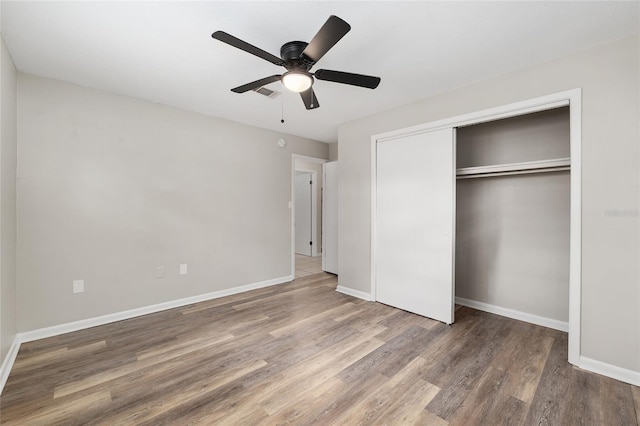 915 NW 40th Ave, Gainesville, Fl, FL 32605 - unfurnished bedroom featuring wood finished floors, a closet, baseboards, and ceiling fan