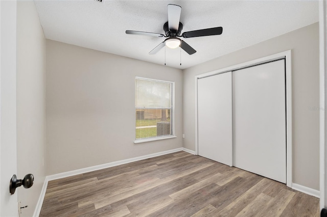 915 NW 40th Ave, Gainesville, Fl, FL 32605 - unfurnished bedroom with wood finished floors, a closet, baseboards, and a ceiling fan