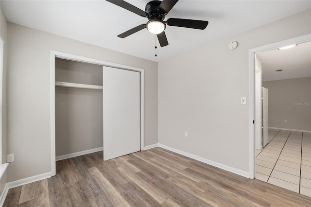 915 NW 40th Ave, Gainesville, Fl, FL 32605 - unfurnished bedroom with wood finished floors, a closet, baseboards, and ceiling fan