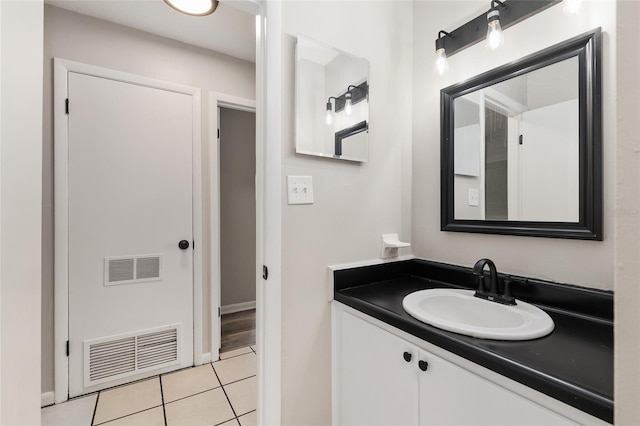 915 NW 40th Ave, Gainesville, Fl, FL 32605 - bathroom with tile patterned floors, vanity, and baseboards
