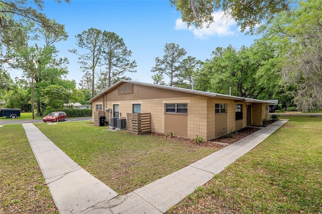 915 NW 40th Ave, Gainesville, Fl, FL 32605 - view of side of property with a yard and central air condition unit
