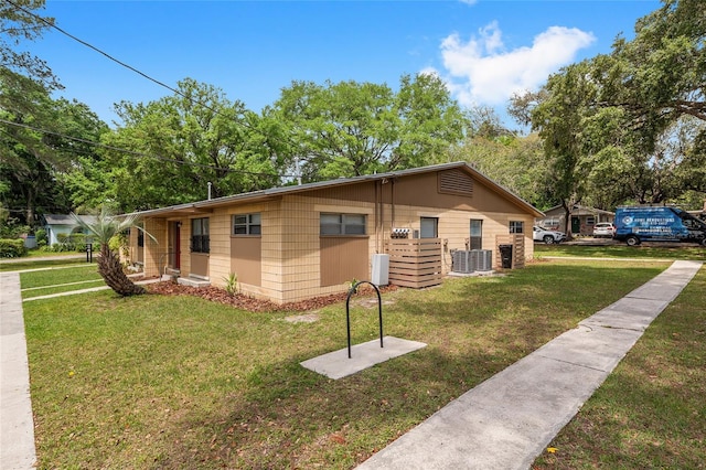915 NW 40th Ave, Gainesville, Fl, FL 32605 - view of front of home featuring a front lawn and central air condition unit