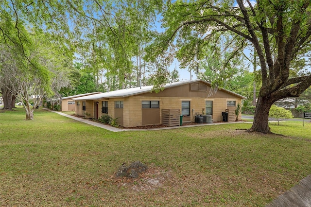 915 NW 40th Ave, Gainesville, Fl, FL 32605 - rear view of property with a lawn and central AC unit