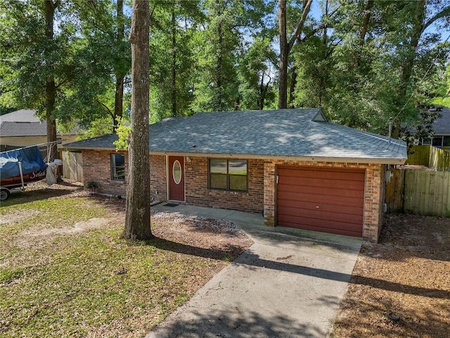 22317 NW 176th Pl, High Springs, FL 32643 - single story home with an attached garage, concrete driveway, a shingled roof, and brick siding