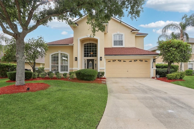 1726 Chatham Village Dr, Fleming Island, FL 32003 - mediterranean / spanish-style house with an attached garage, stucco siding, driveway, a front lawn, and roof with shingles