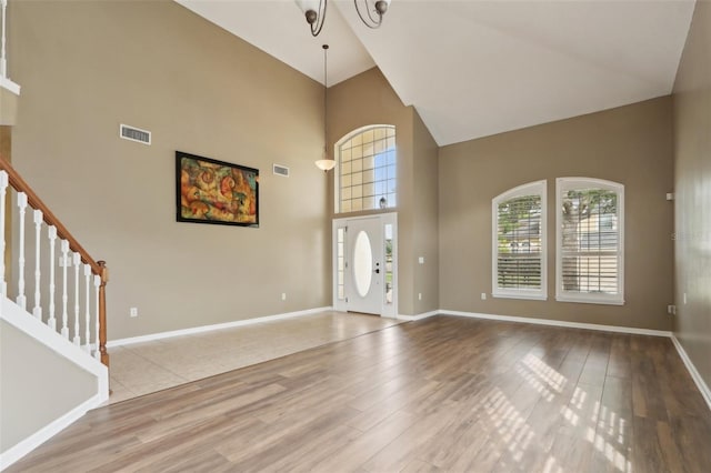 1726 Chatham Village Dr, Fleming Island, FL 32003 - entryway with high vaulted ceiling, wood finished floors, healthy amount of natural light, and stairway