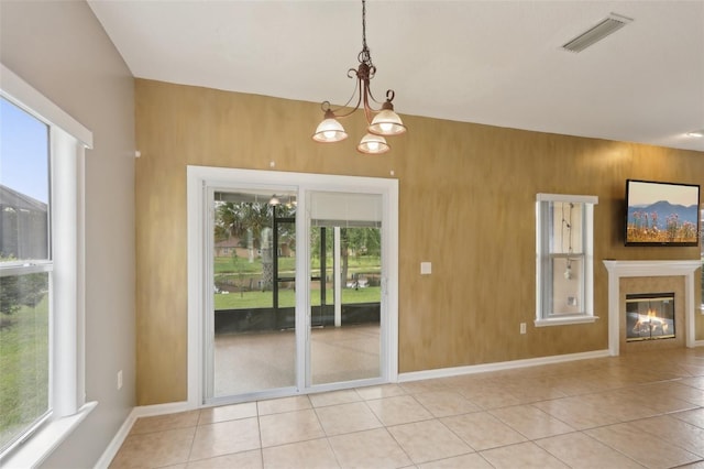 1726 Chatham Village Dr, Fleming Island, FL 32003 - unfurnished dining area featuring plenty of natural light, a chandelier, and light tile patterned flooring