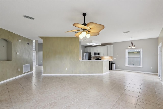 1726 Chatham Village Dr, Fleming Island, FL 32003 - unfurnished living room featuring light tile patterned flooring, baseboards, and a ceiling fan