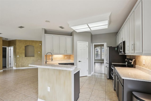 1726 Chatham Village Dr, Fleming Island, FL 32003 - kitchen with stainless steel appliances, light tile patterned flooring, tasteful backsplash, and a sink