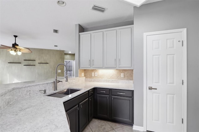 1726 Chatham Village Dr, Fleming Island, FL 32003 - kitchen with a sink, white cabinets, a ceiling fan, backsplash, and light tile patterned floors