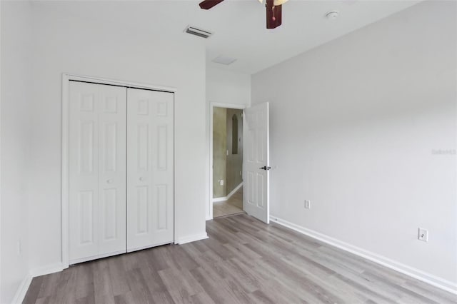 1726 Chatham Village Dr, Fleming Island, FL 32003 - unfurnished bedroom with wood finished floors, a closet, baseboards, and ceiling fan