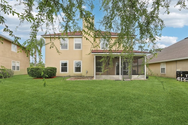 1726 Chatham Village Dr, Fleming Island, FL 32003 - rear view of house with a sunroom, a lawn, stucco siding, and a chimney