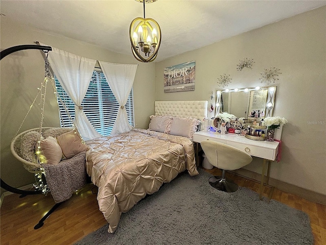 4000 SW 23rd St Unit 3-205, Gainesville, FL 32608 - bedroom with wood finished floors, a chandelier, and baseboards
