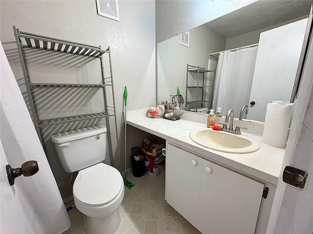 4000 SW 23rd St Unit 3-205, Gainesville, FL 32608 - bathroom featuring vanity, toilet, tile patterned floors, and a textured wall