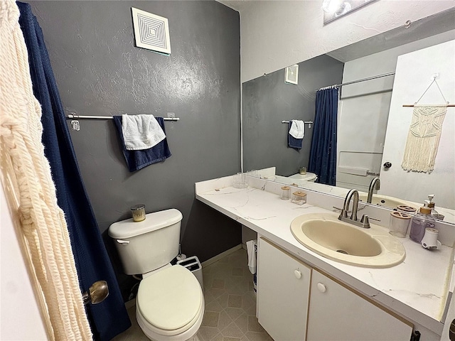 4000 SW 23rd St Unit 3-205, Gainesville, FL 32608 - bathroom featuring toilet, vanity, a shower with shower curtain, and tile patterned flooring