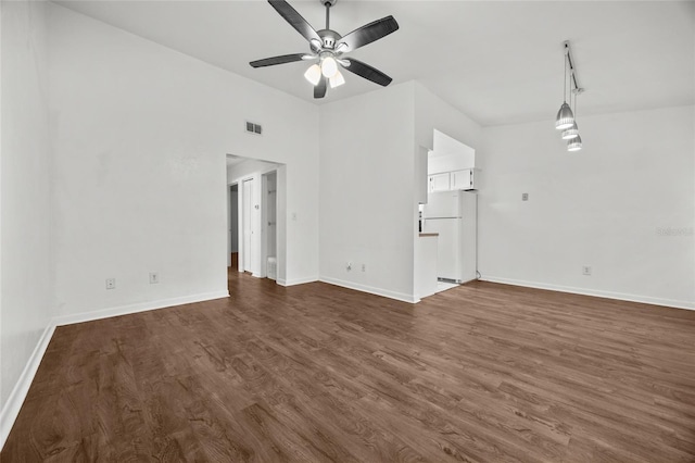 6912 SW 45th Ave, Gainesville, FL 32608 - unfurnished living room featuring dark wood-type flooring, ceiling fan, and baseboards