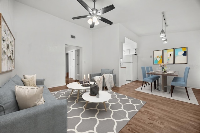 6912 SW 45th Ave, Gainesville, FL 32608 - living room featuring wood finished floors, ceiling fan, and baseboards