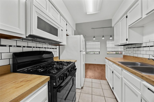 6912 SW 45th Ave, Gainesville, FL 32608 - kitchen featuring white appliances, a sink, white cabinetry, and decorative backsplash