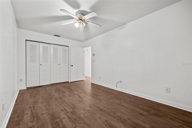 6912 SW 45th Ave, Gainesville, FL 32608 - unfurnished bedroom with baseboards, dark wood-type flooring, and a closet