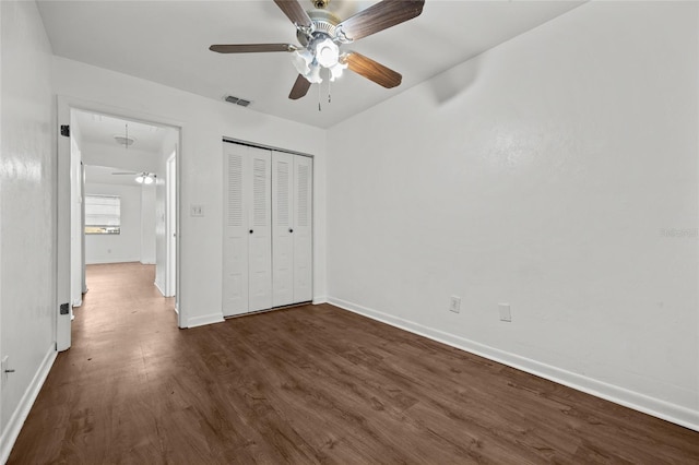 6912 SW 45th Ave, Gainesville, FL 32608 - unfurnished bedroom featuring attic access, dark wood finished floors, baseboards, a closet, and ceiling fan