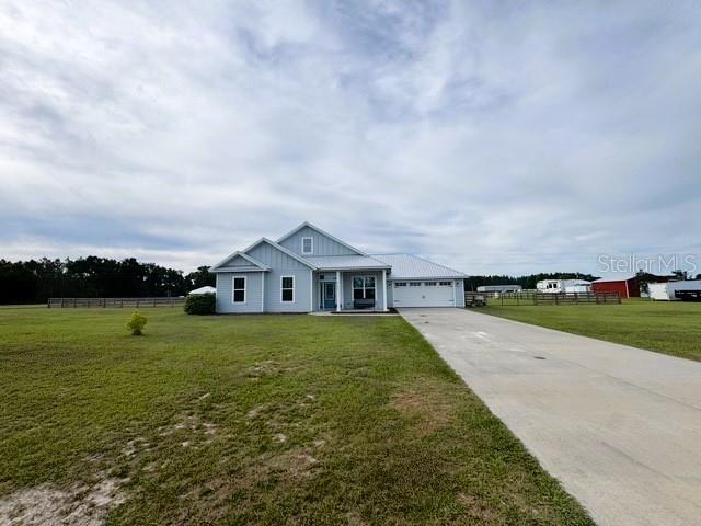 6180 SW 83rd Pl, Trenton, FL 32693 - modern farmhouse featuring concrete driveway and board and batten siding