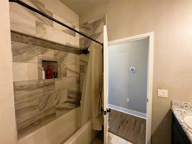 6180 SW 83rd Pl, Trenton, FL 32693 - bathroom with vanity, shower / bath combo with shower curtain, wood finished floors, and baseboards