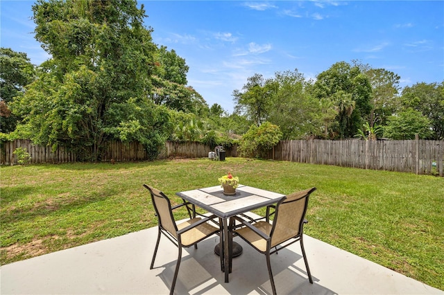 680 NW 67th Pl, Ocala, FL 34475 - view of patio with outdoor dining space and view of wooded area