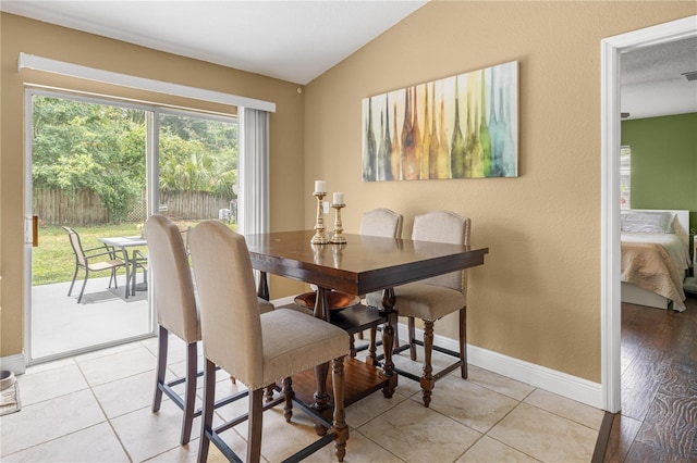 680 NW 67th Pl, Ocala, FL 34475 - dining space featuring vaulted ceiling, baseboards, and light tile patterned floors