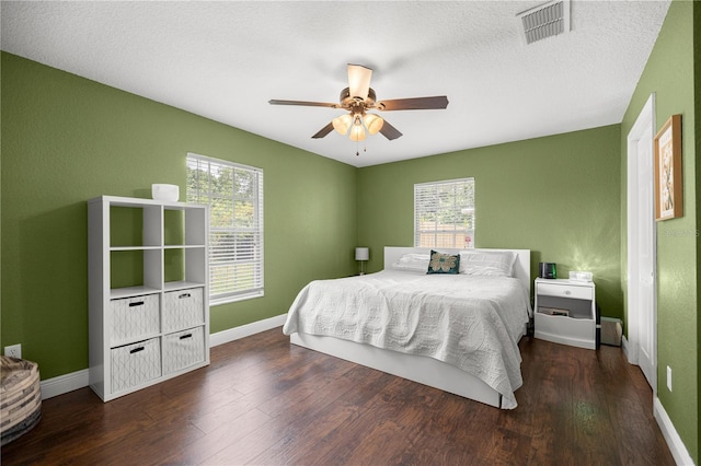 680 NW 67th Pl, Ocala, FL 34475 - bedroom with multiple windows, wood finished floors, baseboards, and a textured ceiling