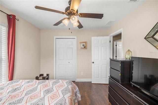 680 NW 67th Pl, Ocala, FL 34475 - bedroom with dark wood-style floors, a closet, ceiling fan, and baseboards