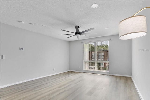 1700 SW 16th Ct Unit J21, Gainesville, FL 32608 - unfurnished room with wood finished floors, a textured ceiling, ceiling fan, baseboards, and a smoke detector