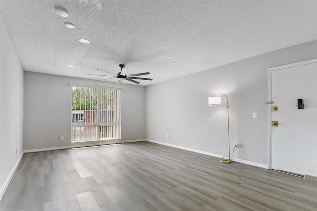 1700 SW 16th Ct Unit J21, Gainesville, FL 32608 - unfurnished room featuring a ceiling fan, wood finished floors, a textured ceiling, baseboards, and a smoke detector