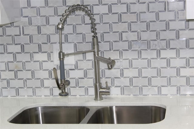 1700 SW 16th Ct Unit J21, Gainesville, FL 32608 - kitchen view of a sink, light stone counters, and tasteful backsplash