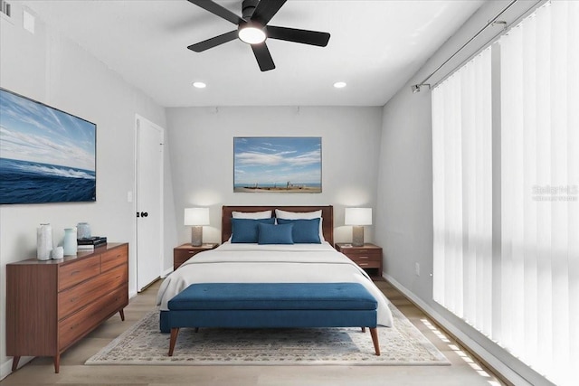 1700 SW 16th Ct Unit J21, Gainesville, FL 32608 - bedroom with light wood-style flooring, recessed lighting, and a ceiling fan