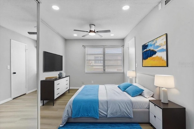 1700 SW 16th Ct Unit J21, Gainesville, FL 32608 - bedroom featuring light wood-type flooring, recessed lighting, ceiling fan, and baseboards