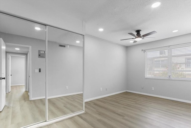 1700 SW 16th Ct Unit J21, Gainesville, FL 32608 - unfurnished bedroom with recessed lighting, wood finished floors, a textured ceiling, baseboards, and ceiling fan