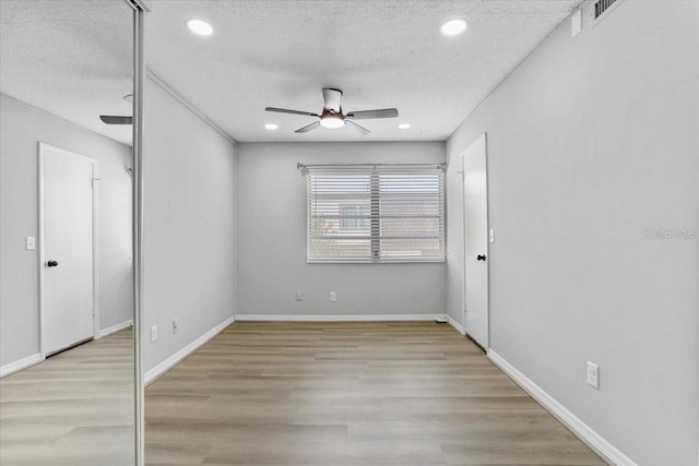 1700 SW 16th Ct Unit J21, Gainesville, FL 32608 - spare room featuring ceiling fan, a textured ceiling, wood finished floors, recessed lighting, and baseboards