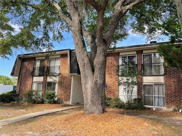1700 SW 16th Ct Unit D30, Gainesville, FL 32608 - view of front of house featuring brick siding and a balcony