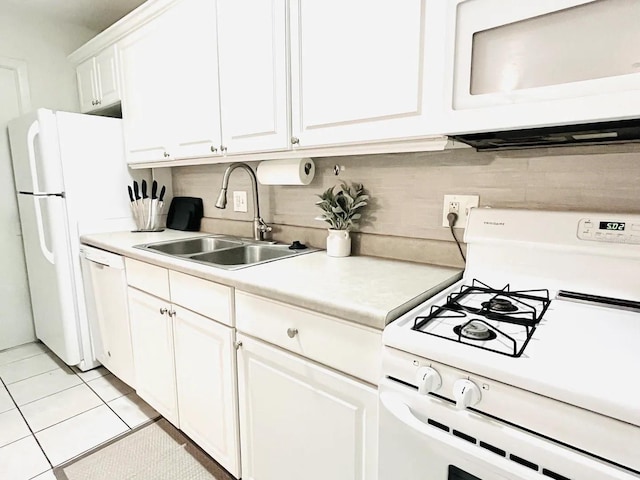 1700 SW 16th Ct Unit D30, Gainesville, FL 32608 - kitchen featuring white appliances, a sink, light countertops, white cabinets, and light tile patterned floors