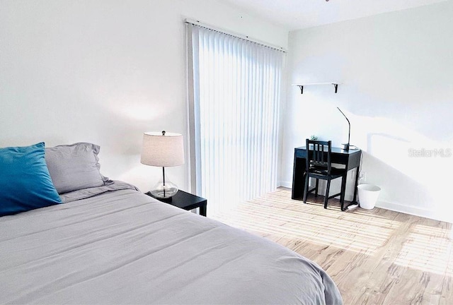 1700 SW 16th Ct Unit D30, Gainesville, FL 32608 - bedroom featuring wood finished floors and baseboards
