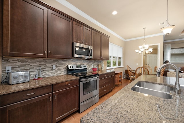 2638 SW 118th Ter, Gainesville, FL 32608 - kitchen featuring appliances with stainless steel finishes, a sink, light wood-style floors, dark brown cabinets, and light stone counters