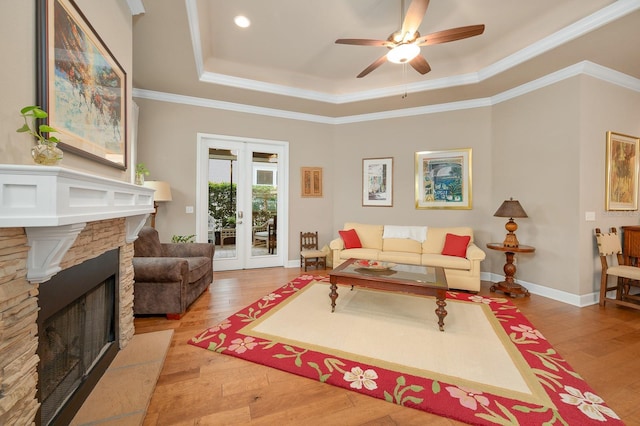 2638 SW 118th Ter, Gainesville, FL 32608 - living room with a raised ceiling, wood finished floors, a ceiling fan, a fireplace, and ornamental molding