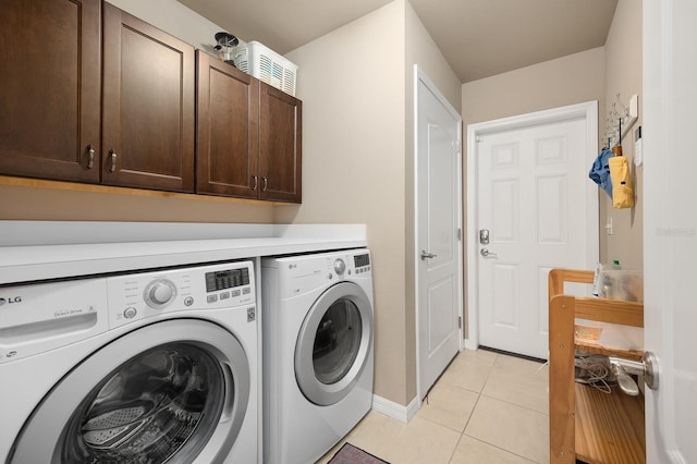 2638 SW 118th Ter, Gainesville, FL 32608 - washroom with cabinet space, washing machine and clothes dryer, light tile patterned flooring, and baseboards