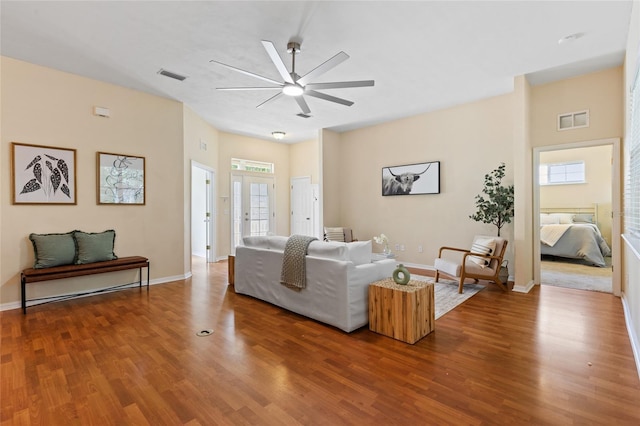 8360 SW 74th Pl, Gainesville, FL 32608 - living area featuring wood finished floors, ceiling fan, and baseboards