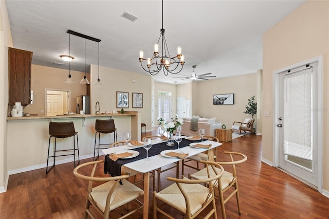 8360 SW 74th Pl, Gainesville, FL 32608 - dining room with wood finished floors, a ceiling fan, a chandelier, and baseboards